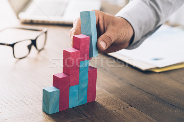 Businessman building a successful financial graph Stock photo © stokkete