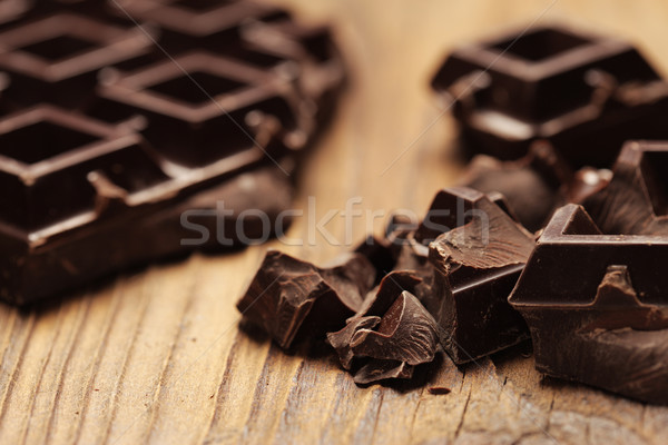 Pieces of dark chocolate  on a wooden background Stock photo © stokkete