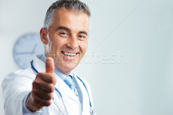 Middle-aged doctor showing thumbs up Stock photo © stokkete