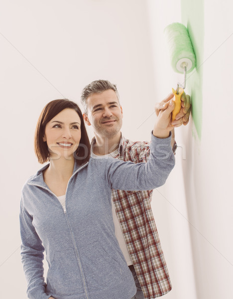 Loving couple painting a room Stock photo © stokkete