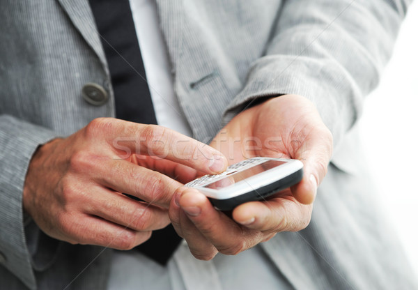 businesman with a smart phone, Closeup of hands Stock photo © stokkete