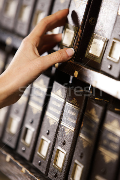 Searching in archives. Student hands searching from a filling ca Stock photo © stokkete