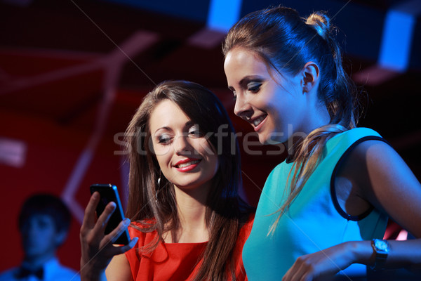 Two women enjoying with a smartphone Stock photo © stokkete