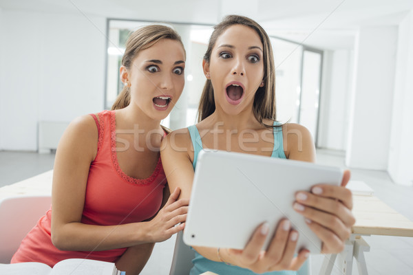 Girls social networking with a tablet Stock photo © stokkete