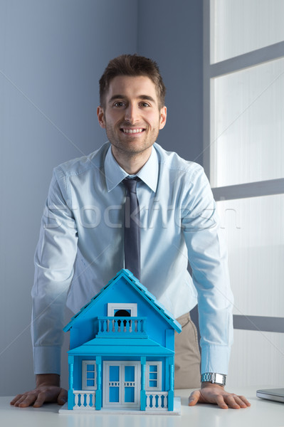 Stock photo: Real estate agent with model house