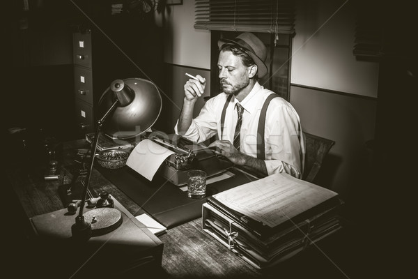 Retro reporter working late and smoking Stock photo © stokkete