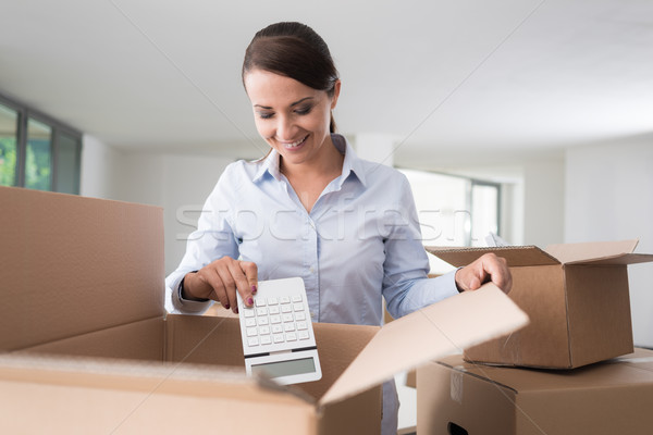 Happy woman unpacking Stock photo © stokkete