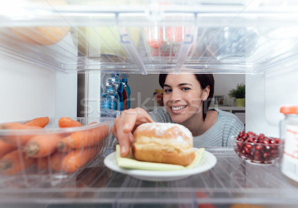 Woman having an unhealthy snack Stock photo © stokkete