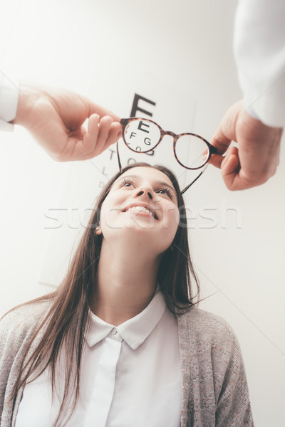 Happy woman trying her new glasses Stock photo © stokkete