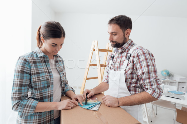 Woman picking a color for her walls Stock photo © stokkete