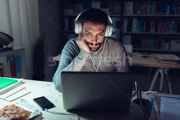 Handsome man connecting late at night Stock photo © stokkete