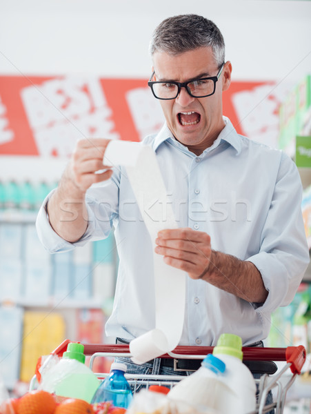 Człowiek długo paragon spożywczy zakupy Zdjęcia stock © stokkete