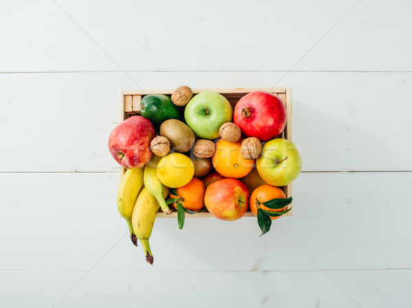 Fresh tasty fruit in a wooden crate Stock photo © stokkete