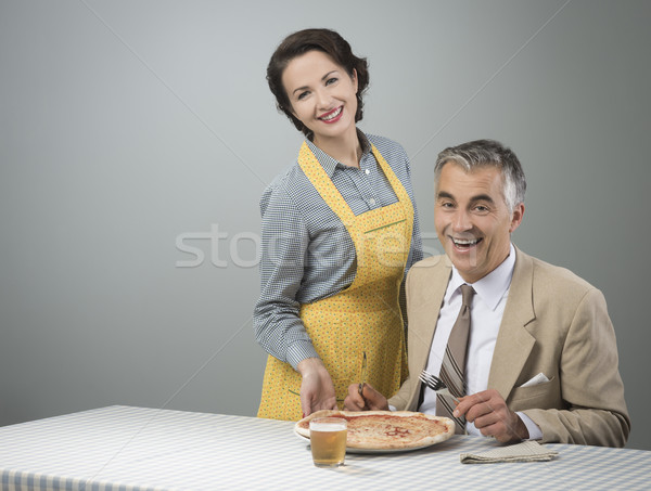 Smiling wife serving dinner Stock photo © stokkete