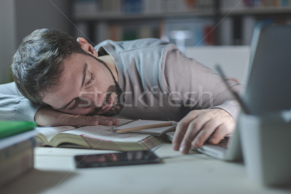 Sleepy young man at desk Stock photo © stokkete