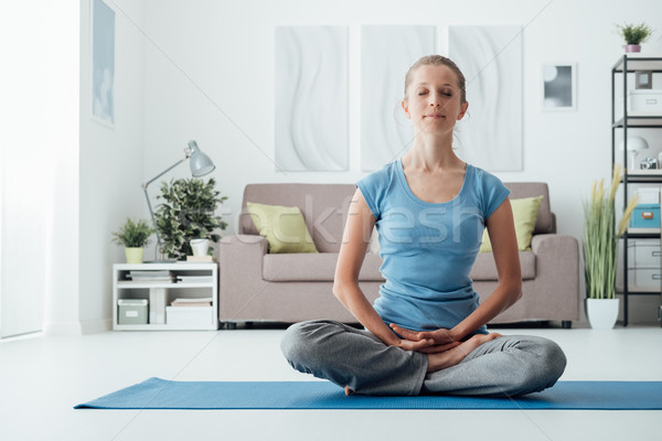 Woman practicing yoga at home Stock photo © stokkete