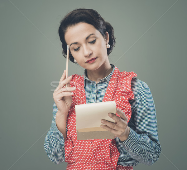 Housewife writing down a shopping list Stock photo © stokkete