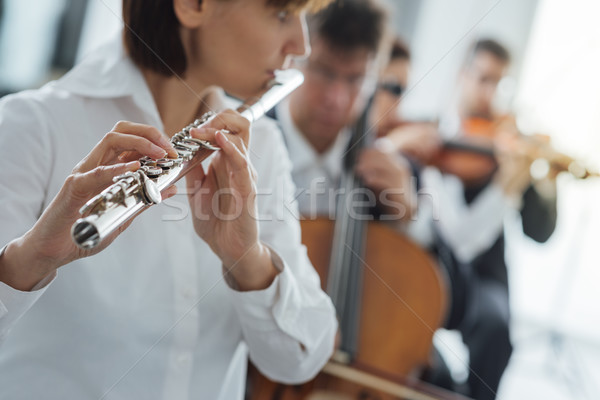 Flutist playing her instrument on stage Stock photo © stokkete
