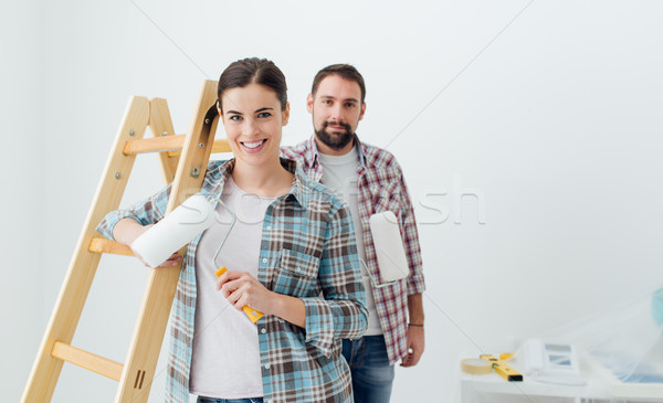 Happy couple painting their new home Stock photo © stokkete