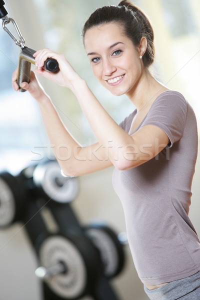 Glimlachend jonge vrouw gewicht machine gezondheid club Stockfoto © stokkete