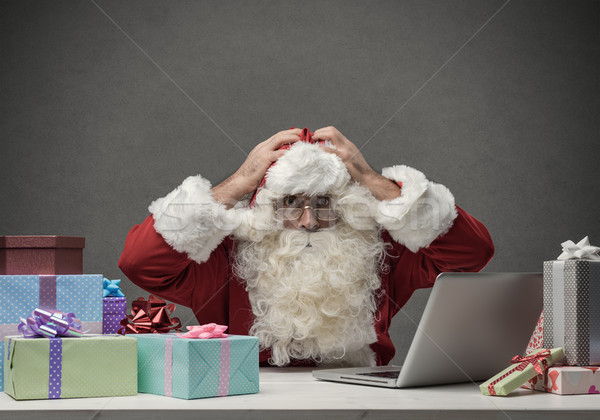 Stressed Santa connecting with his laptop Stock photo © stokkete