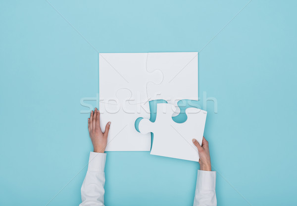 Woman assembling a jigsaw puzzle Stock photo © stokkete