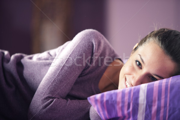 Closeup of a young woman lying on bed Stock photo © stokkete