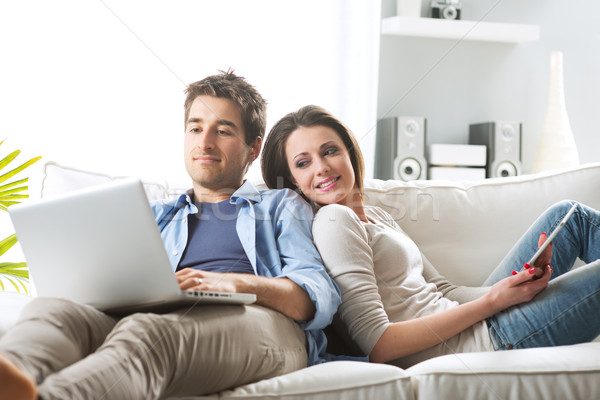 Couple surfing the net at home Stock photo © stokkete