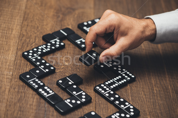 Businessman playing with dominoes Stock photo © stokkete