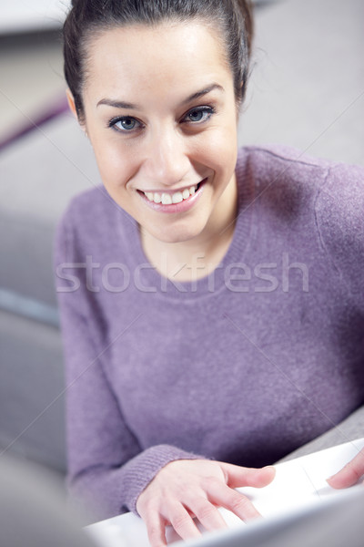 Stock photo: at home: young woman working on her laptop
