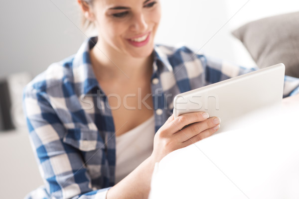 Relaxing in the living room with tablet Stock photo © stokkete