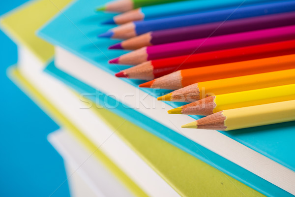 Colorful pencils on stack of books Stock photo © stokkete