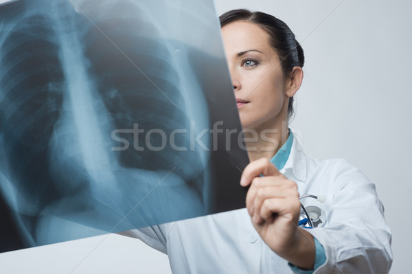 Female doctor examining x-ray image Stock photo © stokkete