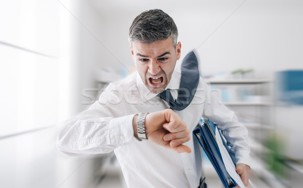 Businessman in a hurry checking time Stock photo © stokkete