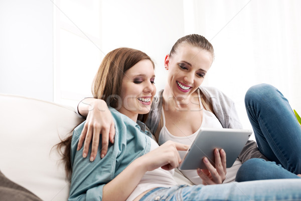 Happy lesbian couple with tablet Stock photo © stokkete