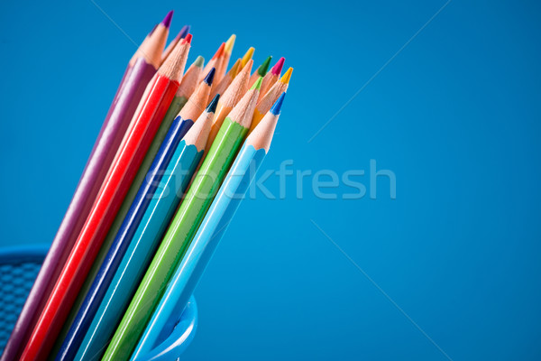 Colorful pencils on blue background Stock photo © stokkete