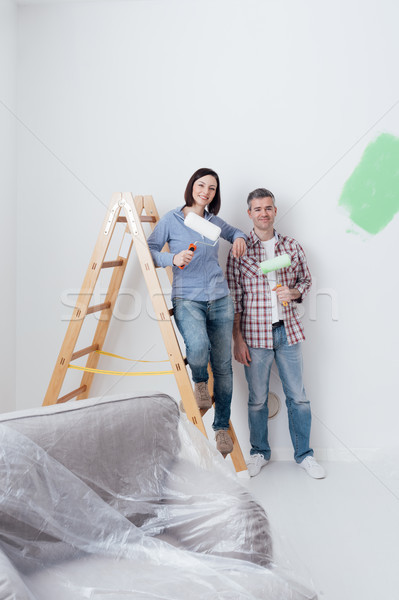 Stock photo: Happy couple renovating their home