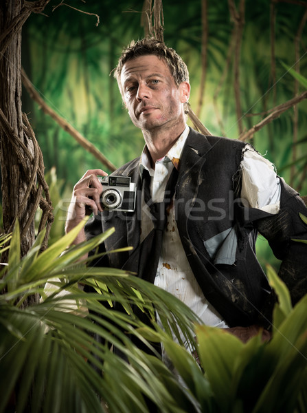 Photoreporter walking in the jungle with vintage camera Stock photo © stokkete