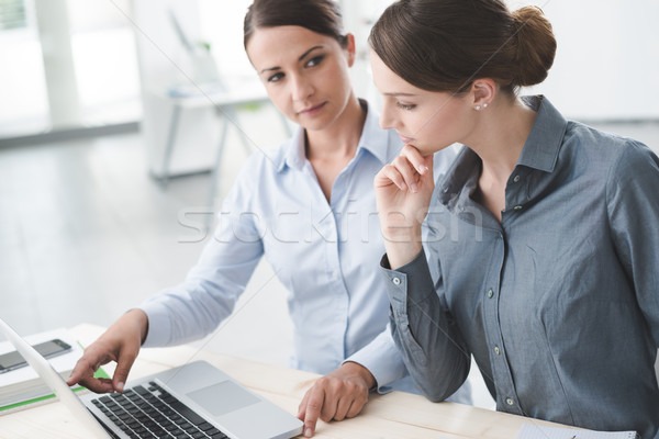 Stock photo: Business women working together on a laptop