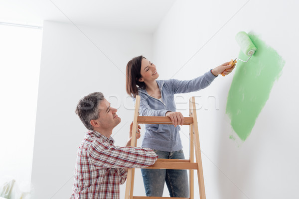 Couple painting walls together Stock photo © stokkete