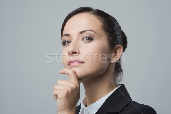 Confident female manager with hand on chin Stock photo © stokkete