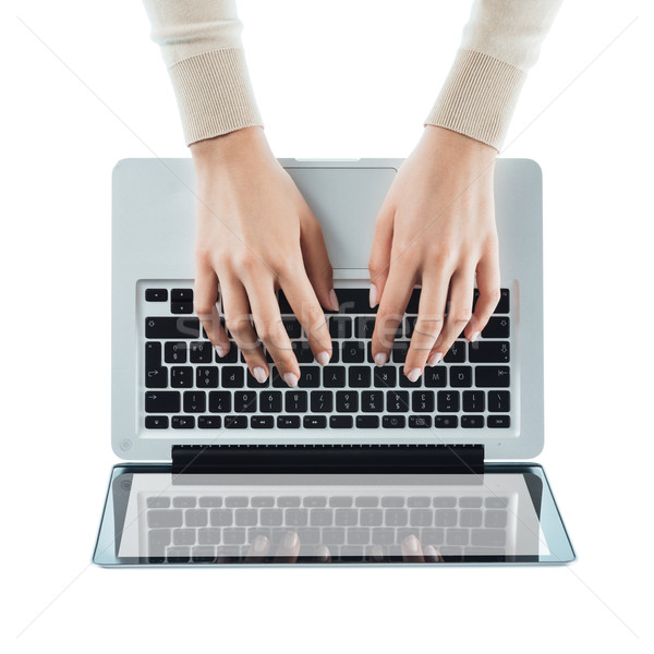 Blogger typing on a laptop Stock photo © stokkete