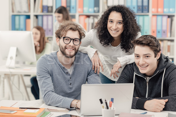 Group of students connecting with a laptop Stock photo © stokkete