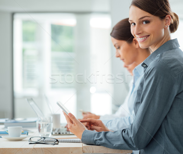 Business Woman Working At Office Desk With Her Colleagues Stock