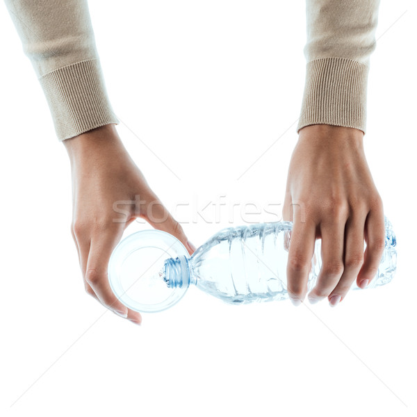 Young woman pouring water in a glass Stock photo © stokkete