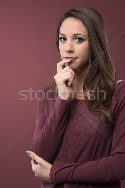 Pensive woman with hand on chin Stock photo © stokkete