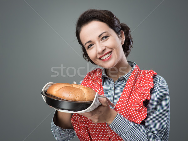 Vintage housewife holding an homemade cake Stock photo © stokkete