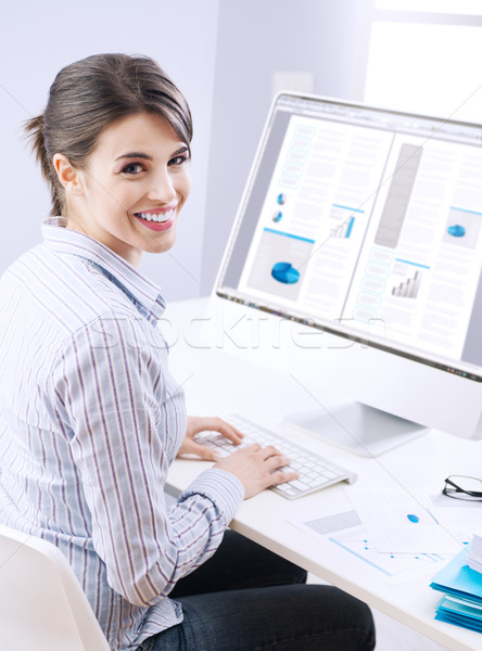 Cute businesswoman smiling at desk Stock photo © stokkete