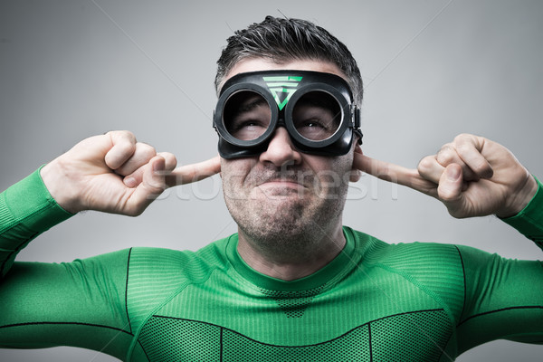 Superhero plugging ears with fingers Stock photo © stokkete