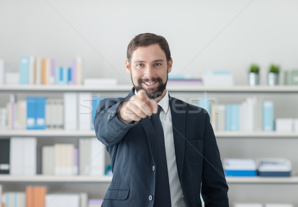 Smiling businessman pointing at camera Stock photo © stokkete